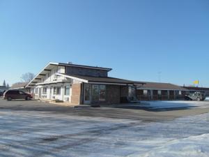 an empty parking lot in front of a building at Virden Motel in Virden