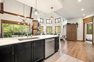 a kitchen with a sink and a counter top at Tremblant Prestige - Manoir 108-2 in Mont-Tremblant
