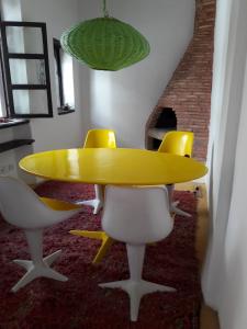 a yellow table and chairs in a room at Luxury Riad des Arts in Essaouira +21 photos