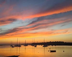 a group of boats in the water at sunset at Cabines Catamaran Breakfast-Brunch Included, Optional Lunch & Dinner in Alvor