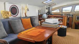a living room with a couch and a wooden table at Cabines Catamaran Breakfast-Brunch Included, Optional Lunch & Dinner in Alvor