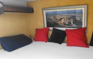 a bed with red and black pillows and a window at Cabines Catamaran Breakfast-Brunch Included, Optional Lunch & Dinner in Alvor +19 photos