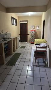 a large room with a kitchen with a table in it at Gray house in Paracuru +14 photos