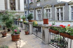 a bunch of potted plants on a fence at Omega Guesthouse Budapest in Budapest