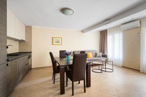 a kitchen and dining room with a table and a couch at Spacious Comfort in Boreti