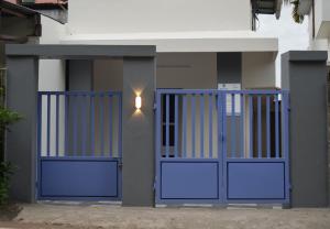a blue gate in front of a house at FlexTays Campus - Budget Student Stays in Trivandrum