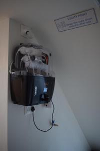 a machine hanging on a wall in a room at FlexTays Campus - Budget Student Stays in Trivandrum