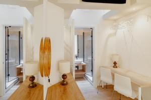 a dining room with a wooden table and a surfboard on the wall at Duomo - Camere matrimoniali con bagno privato in Florence