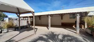 a building with a white roof and a wooden deck at mobilcapagde in Le Grau-dʼAgde