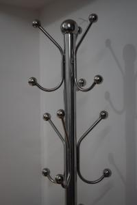 a metal towel rack with four glass hooks at FlexTays Campus - Budget Student Stays in Trivandrum