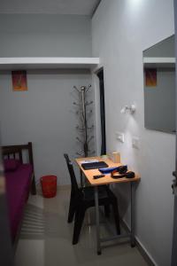a table in a room with a table and chairs at FlexTays Campus - Budget Student Stays in Trivandrum