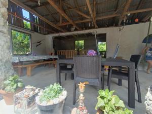 a patio with tables and chairs and potted plants at Vera's Home in Anaklia +15 photos