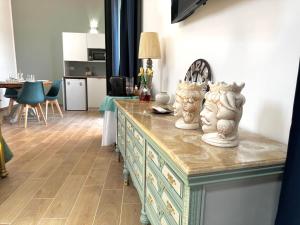 a room with a dresser with two statues on it at Dimora Lilly in Acireale