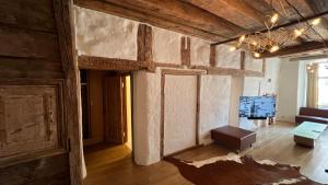 a living room with wooden walls and a chandelier at Luxury Suites in the Heart of Medieval Tallinn Old Town in Tallinn +30 photos