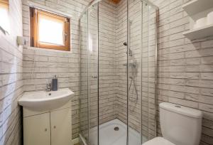 a bathroom with a shower and a sink and a toilet at ZŁOTY OGRÓD in Darłowo +33 photos