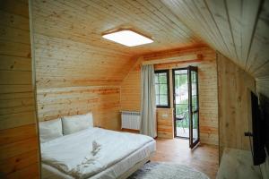 a bedroom with a bed in a wooden room at My House Resort in Dsegh +49 photos
