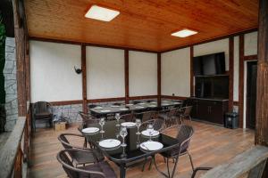 a large room with tables and chairs in it at My House Resort in Dsegh