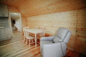 a room with a table and chairs and a chair and a couch at My House Resort in Dsegh