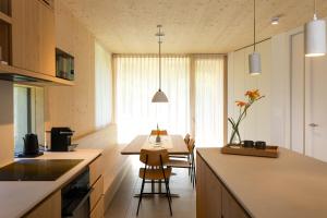 a kitchen with a table and a dining room at Chalet Bohinj Bliss Wellness and view of Triglav in Bohinj