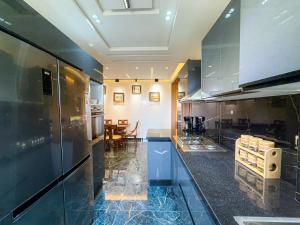 a kitchen with stainless steel appliances and a dining room at Essalmi Luxury Apartment in Marrakech in Marrakech +41 photos