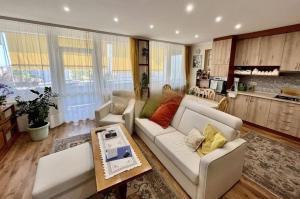 a living room with a couch and a table at Petofi Downtown in Kecskemét