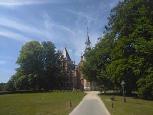 an old building with a path in front of it at Green garden in Torhout