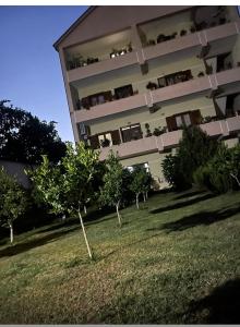 a building with trees in front of it at Quiet Room, close to Airport in Kamëz