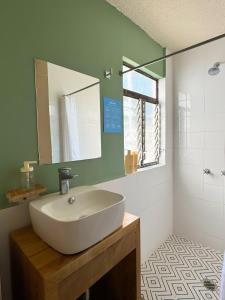 a bathroom with a white sink and a mirror at Habitación privada La Americana Chapultepec in Guadalajara +4 photos
