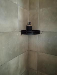a bathroom with a soap dispenser on a wall at Mels in Richards Bay