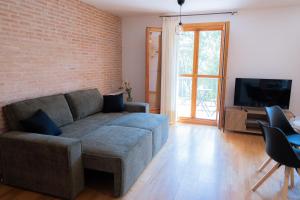 a living room with a couch and a tv at El Rincon de Beceite in Beceite