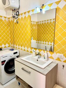 a bathroom with a sink and a washing machine at Studio In The Gulf of Marinella in Marinella