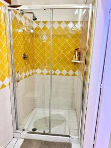 a shower with a glass door in a bathroom at Studio In The Gulf of Marinella in Marinella