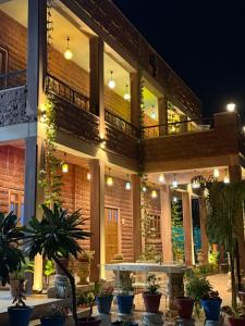 a building with potted plants in front of it at night at The Sunrise Retreat in Jodhpur