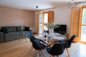 a living room with a table and chairs and a couch at El Rincon de Beceite in Beceite