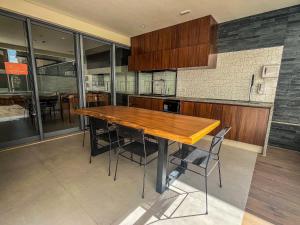 a kitchen with a wooden table and some chairs at Loft - Conforto e Design - Vila Mariana in Sao Paulo