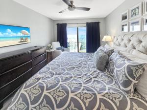 a bedroom with a large bed with a view of the ocean at AWave From It All lakefront on Big Spirit Lake in Orleans