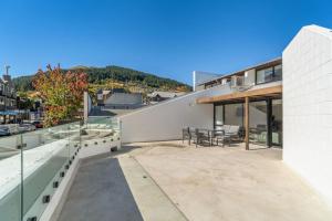 a balcony with a table and chairs on a building at Central on Shotover 2 in Queenstown
