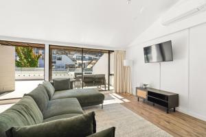 a living room with a couch and a television at Central on Shotover 2 in Queenstown