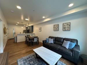 a living room with a couch and a table at Juneau Ground Floor Oasis A105 in Juneau