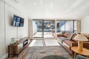 a living room with a couch and a table at Central on Shotover 1 in Queenstown