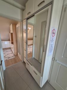 a room with a glass door with a no smoking sign at Quelle Apartment in Kecskemét