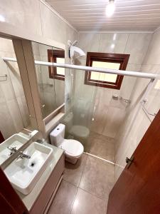 a bathroom with a sink and a toilet at Cabana das Montanhas in Caxias do Sul +14 photos