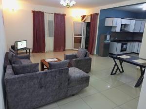 a living room with two couches and a table at résidence rosalie in Kofa