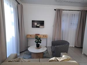 a living room with a couch and a table at Garden studio flat in Panorama