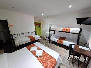a room with two beds and a desk and a desk at Hotel y Spa Termas del Este in Federación +52 photos