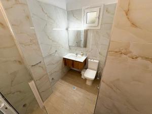 a bathroom with a toilet and a sink and a shower at Afroditi Beach in Gerakini