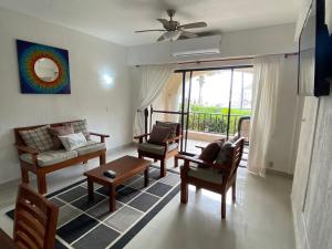 a living room with a couch and chairs and a window at Depa vista al mar in Playa del Carmen