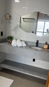 a bathroom counter with a sink and a mirror at Tropical Business Apto 614 in Manaus +19 photos