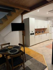 a kitchen with a table and a refrigerator at Laurentroom Townhouse in Ukmergė