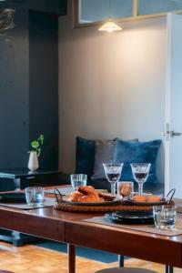 a table with a tray of bread and wine glasses at 田 Den Kamakura Petと泊まれる ペット滞在費別途 in Kamakura +23 photos